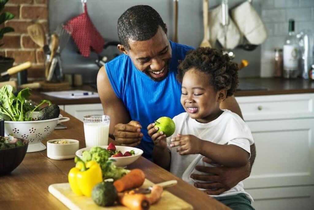 Father feeds his child a healthy breakfast.