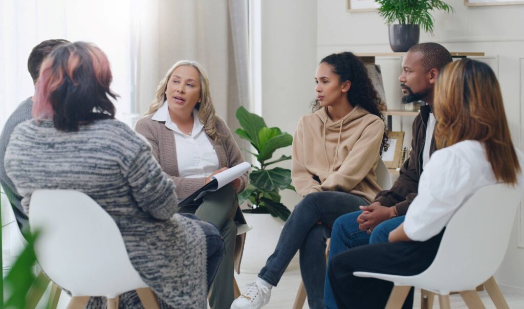 A mental health professional works in a group therapy session
