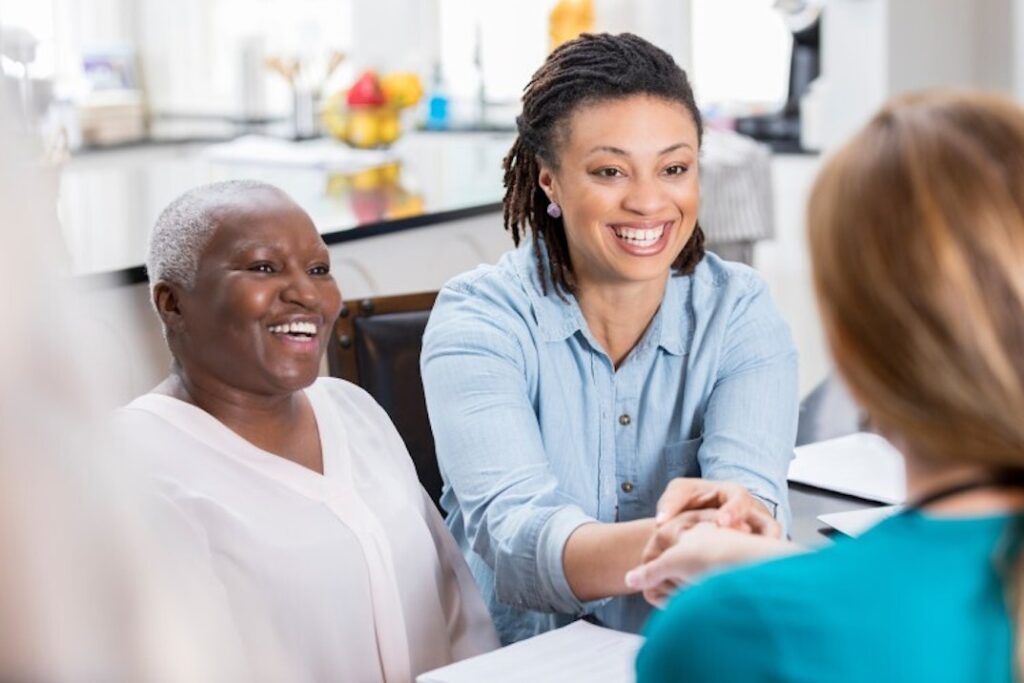 A patient advocate helps a patient consult with a nurse.