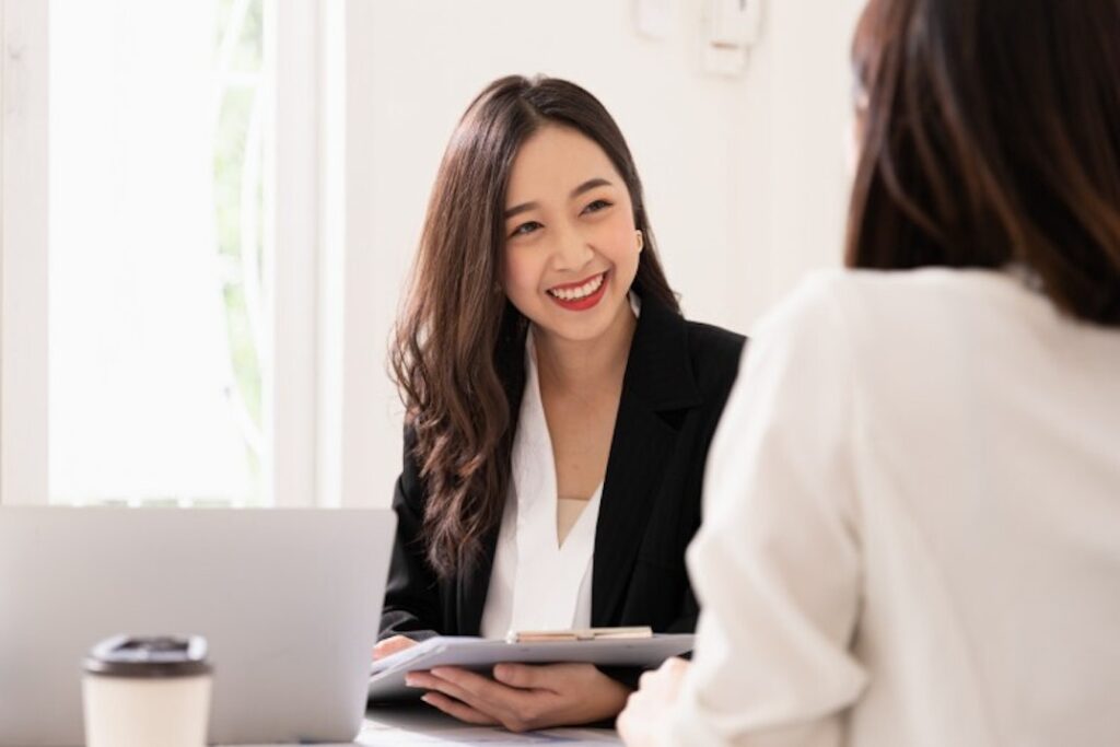 A health services manager interacts with a colleague.