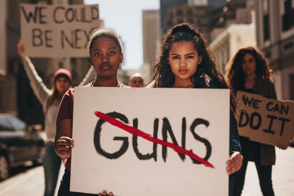 A group of protestors holding anti-gun-violence signs.