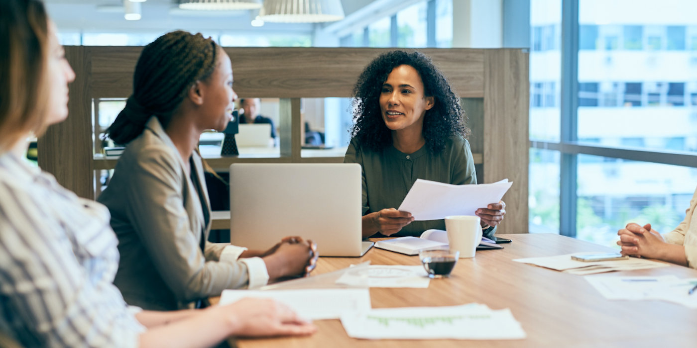 Students study together around a conference table.