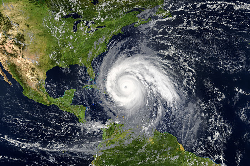 A satellite image of a hurricane forming over a body of water.