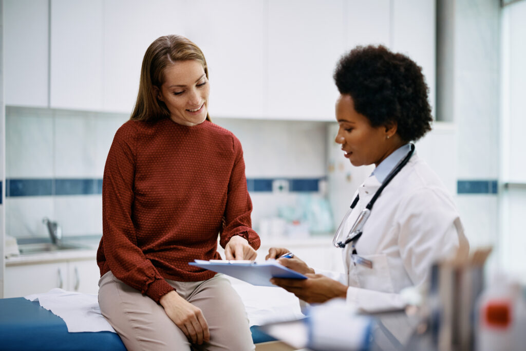A healthcare provider discusses treatment plans with a patient in a healthcare facility