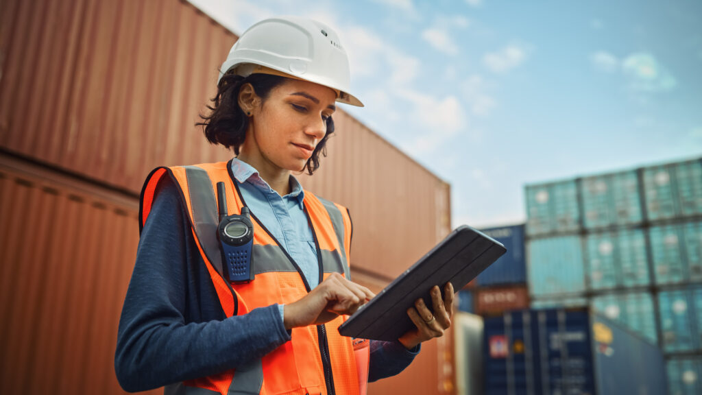 Product safety engineer looking at a tablet at a work site