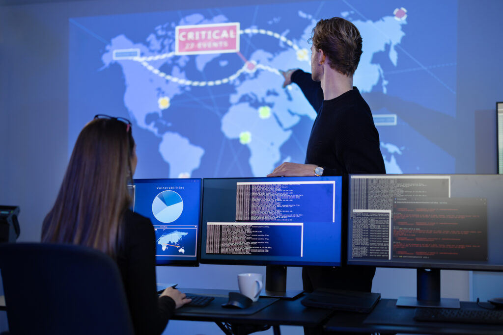 A disaster management professional points to a world map.
